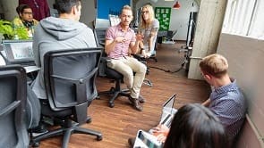 High angle view of casual men and women working at conference table in office meeting